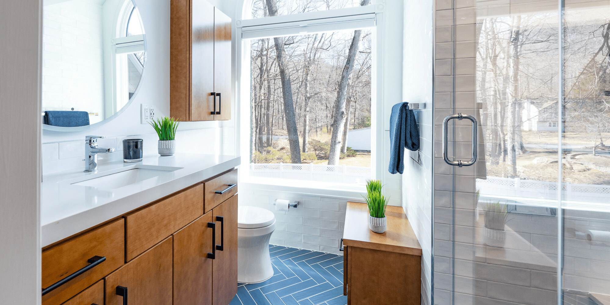 Interior of Bathroom Renovation in NJ with Natural Wood Vanity and Tiled Floor